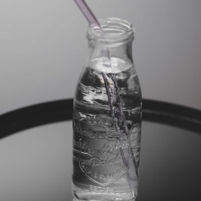 Water bottle on a dark reflective surface